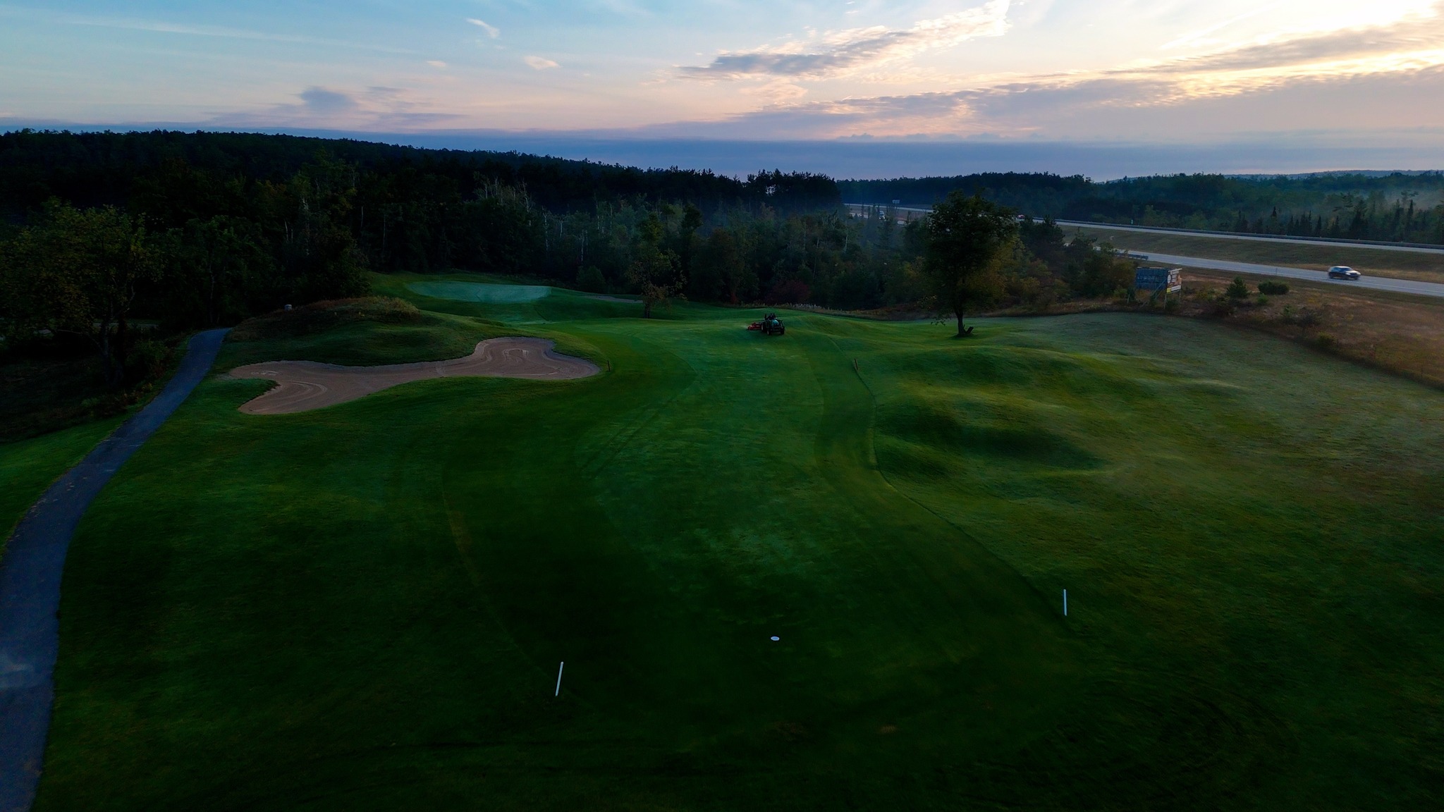 Image of golf ball on tee on grass.